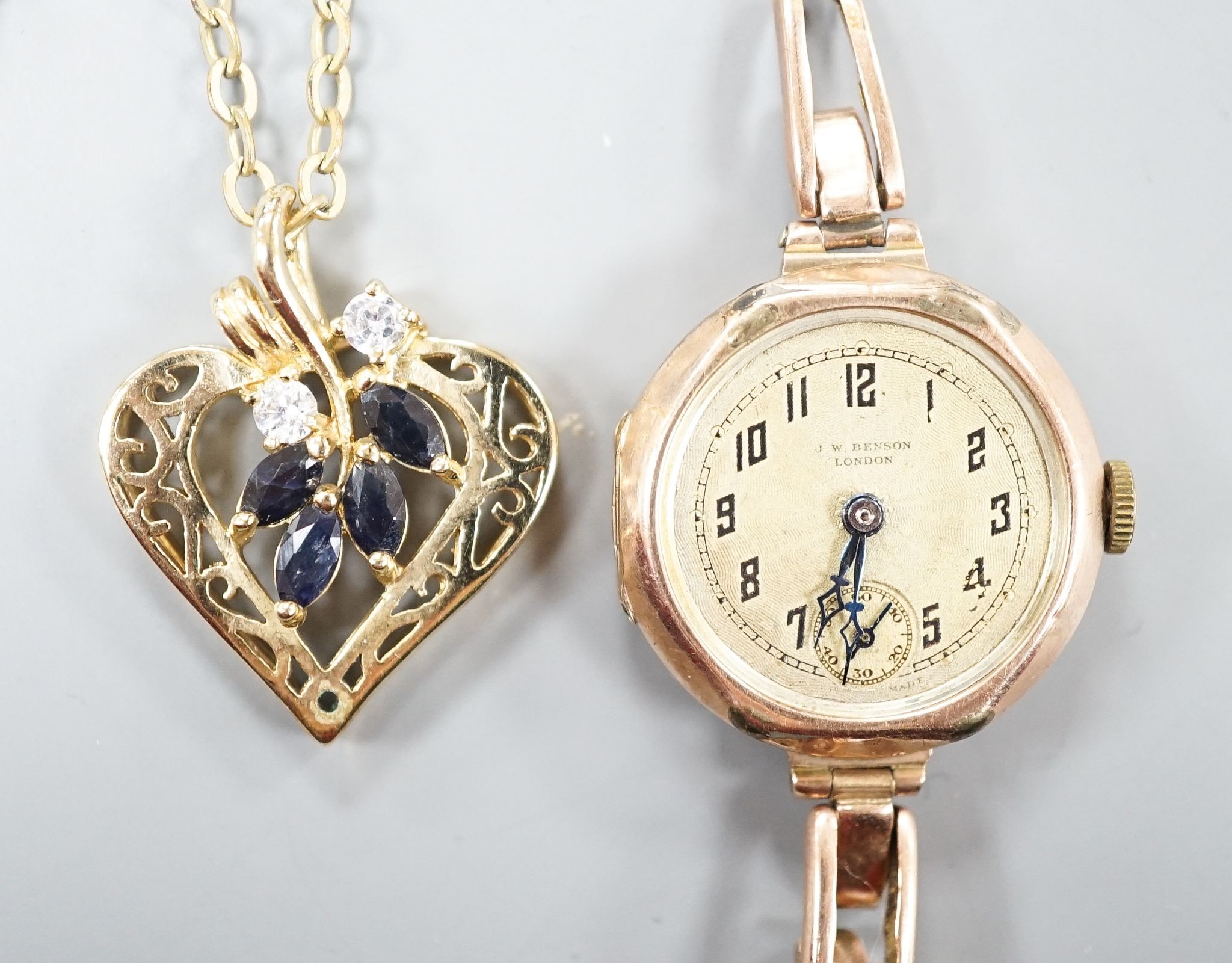 A lady's early 20th century 9ct gold manual wind wrist watch, on a 9ct strap(a.f.), gross weight 21.2 grams and a costume pendant on chain.